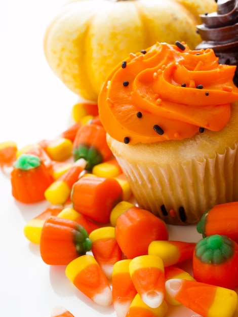 Halloween orange and black cupcakes on white background.