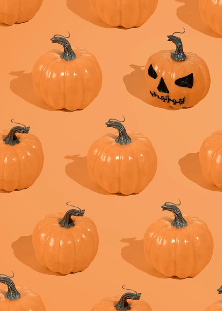 Halloween orange pumpkins pattern on an orange background