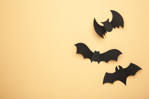 Halloween paper bats on biege.