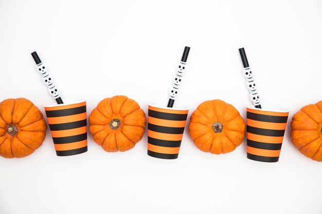 Halloween party background with pumpkins and cups