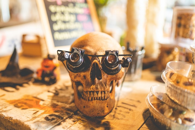 Halloween party concept decorate in cafe decoration with human skull and pumpkin in holiday