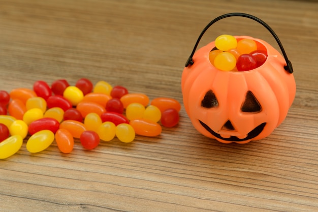 Halloween pumpkin basket full of candies 