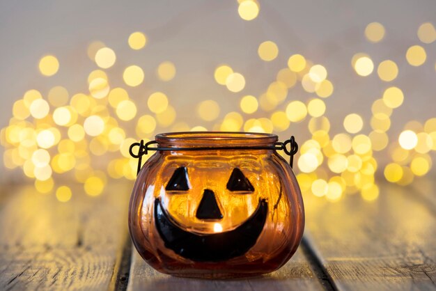 Halloween pumpkin lantern with bokeh fairy lights background