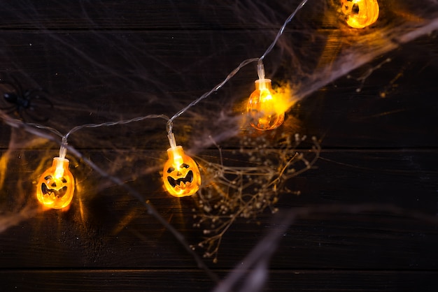 Photo halloween pumpkin orange jack o'lantern smiling face with as candle light lit