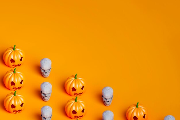 Halloween pumpkin and white skull covering half of the orange background 3d illustration