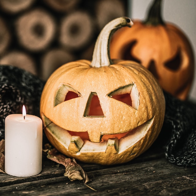 Halloween pumpkin with candle on wood.