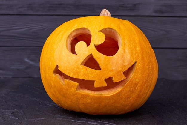 Halloween pumpkin with funny face on black background.