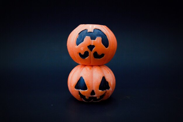 Halloween pumpkins on the black paper background. Halloween background. Space for text. copy space.