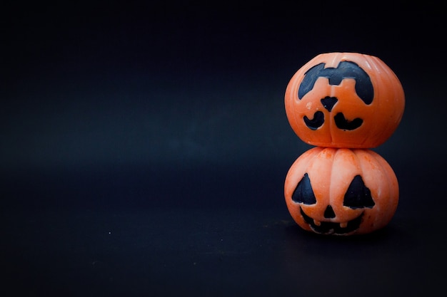 Halloween pumpkins on the black paper background. Halloween background. Space for text. copy space.