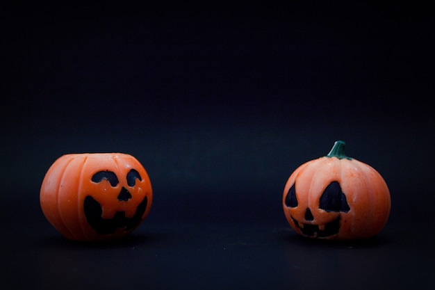 Halloween pumpkins on the black paper background. Halloween background. Space for text. copy space.