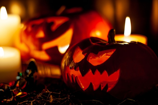 Halloween pumpkins and candles on a dark room