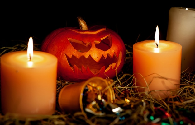 Halloween pumpkins and candles on a dark room