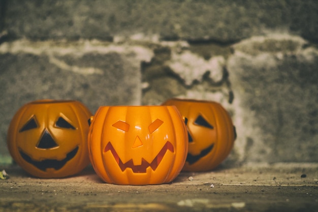 Halloween pumpkins on an old wall