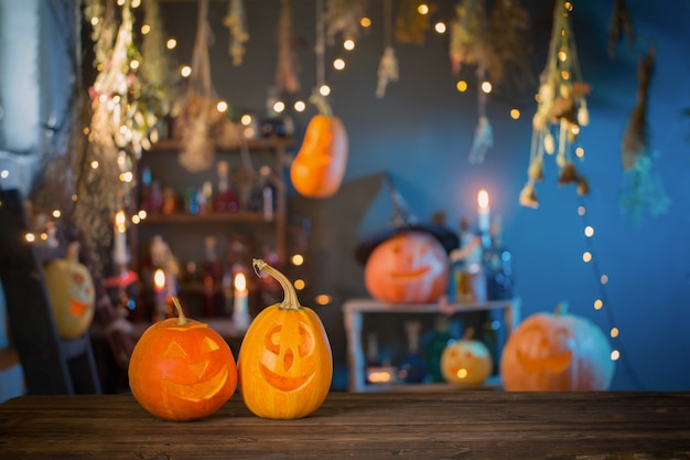 Halloween pumpkins on old wooden table on background Halloween decorations