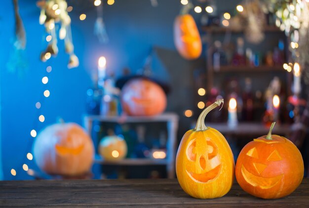 Halloween pumpkins on old wooden table on background Halloween decorations