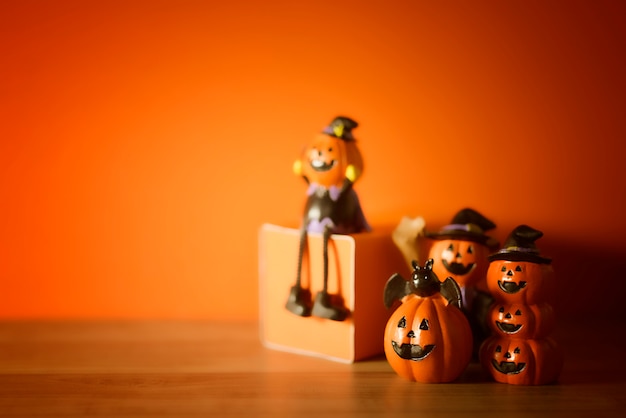 Halloween pumpkins on orange and wooden background.
