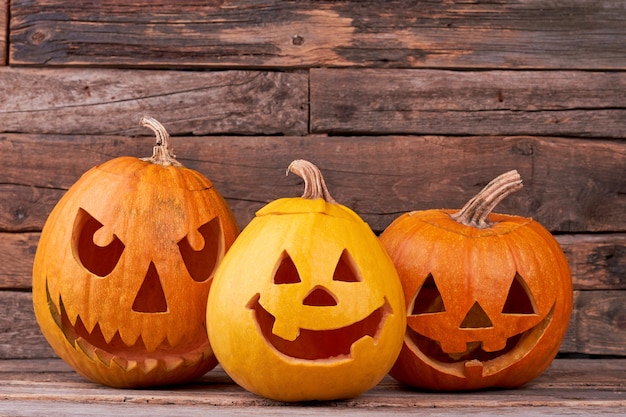 Halloween pumpkins on wooden background.