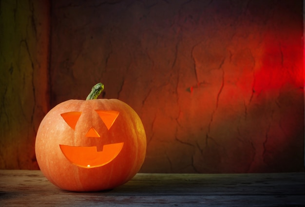 Halloween pumpkins on wooden table on dark background