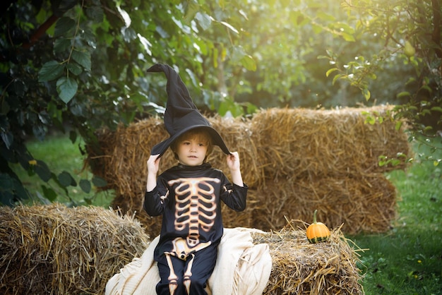 Halloween skeleton kid Happy boy in costume on a celebration of Halloween Little boy at a Halloween