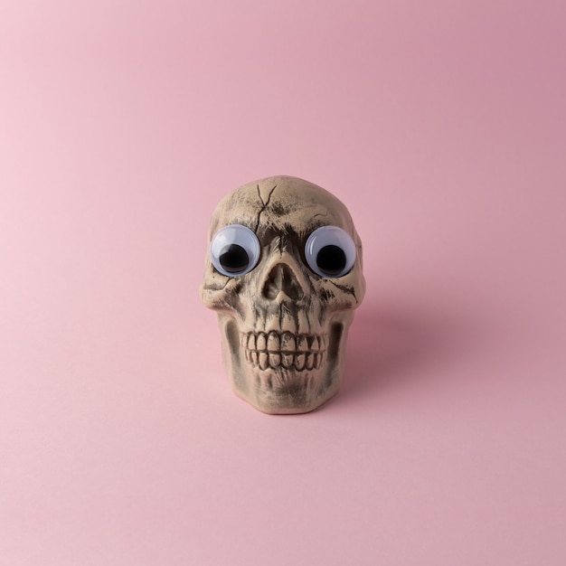 Halloween skull head on a pink background