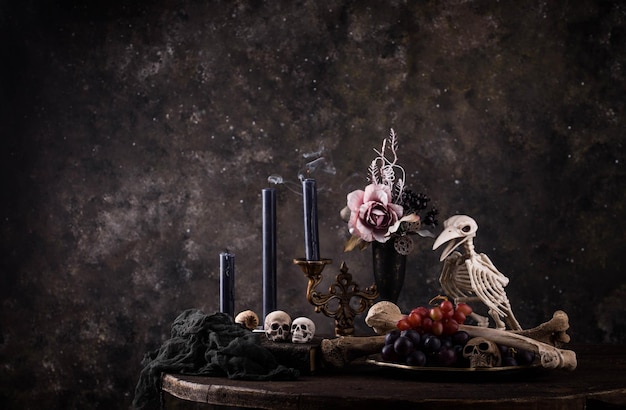 Halloween still life with skull bones and cake