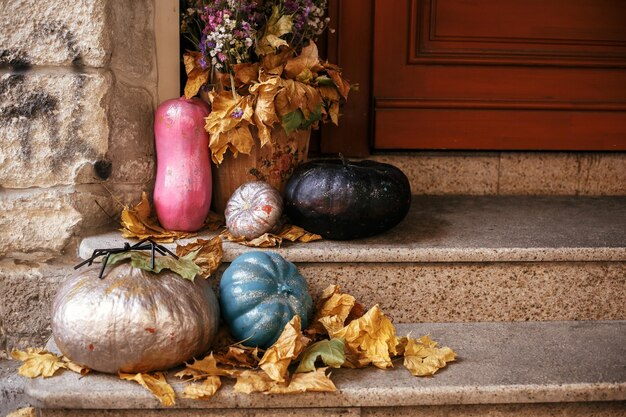 Halloween street decor Colorful pumpkins and painted squash in city street holiday decorations store fronts and buildings Space for text Trick or treat Happy halloween Autumn market