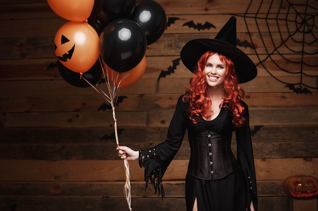 Halloween Witch Concept - Beautiful caucasian woman in witch costumes celebrating Halloween posing 