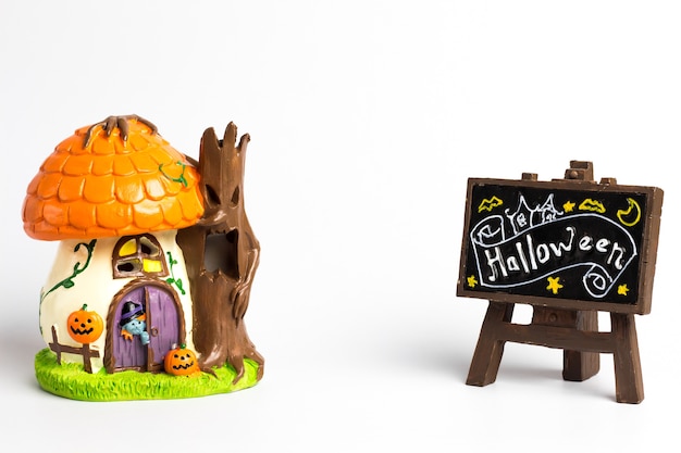 Halloween witch house and brown label with a halloween text.