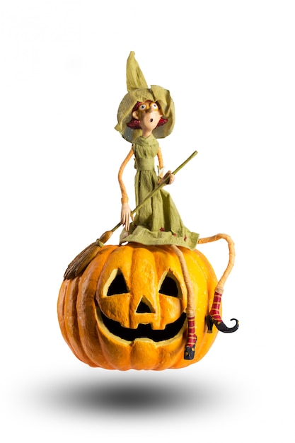 Halloween Witch sit on carved Pumpkin 