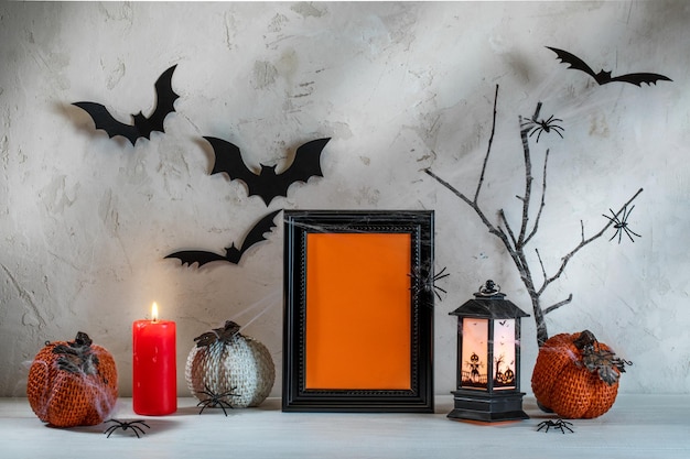 Hallowen festive decorations on white wooden table on textured backdrop mock up copy space