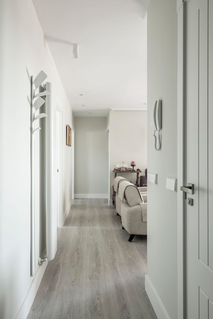 Hallway of a vacation rental home with a long radiator and armchairs