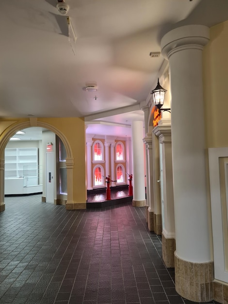 A hallway with a large column and a light on the ceiling
