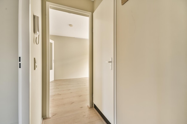 A hallway with white walls and a sliding glass door