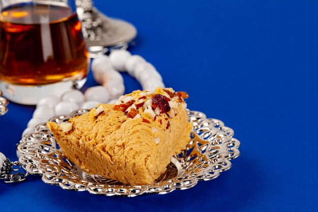 Halva dessert with tea cup on blue table