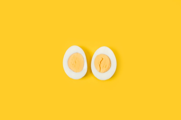 Halved boiled egg on a yellow background