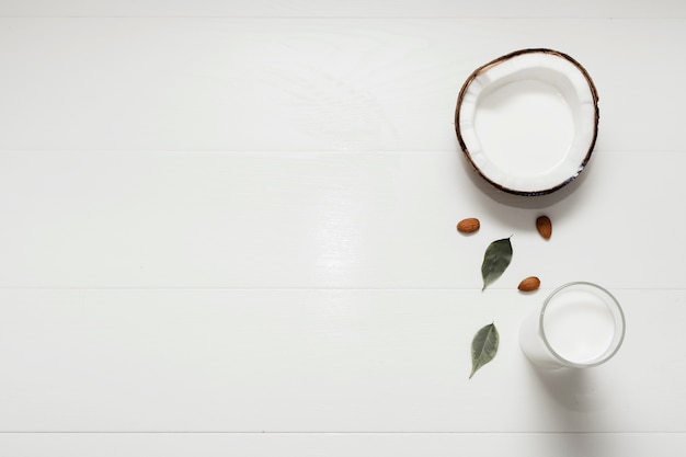 Halved coconut on white background with copy space