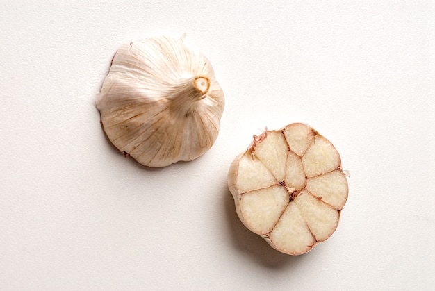 Halved garlic head on white background.