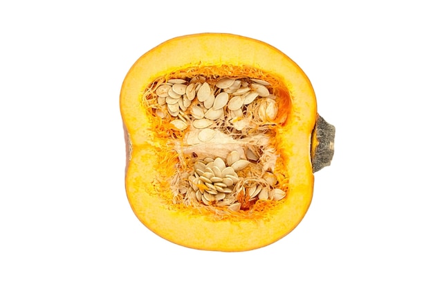 Halved pumpkin with seeds in flesh isolated on white