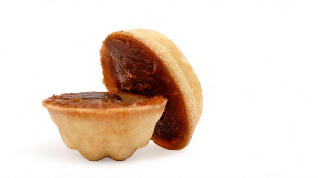 Photo halves of fresh and tasty cookies in the shape of a walnut with boiled condensed milk on a white