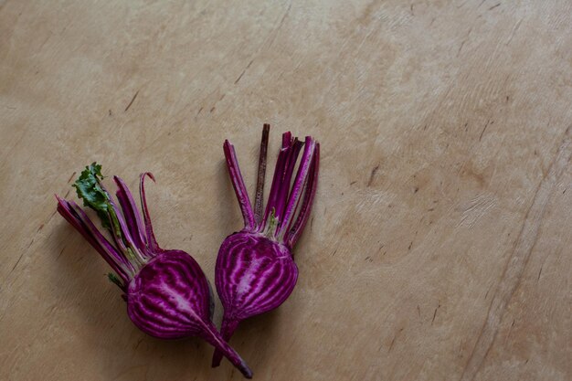 Halves of raw beet on wooden table