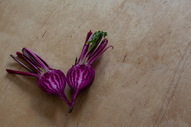 Halves of raw beet on wooden table