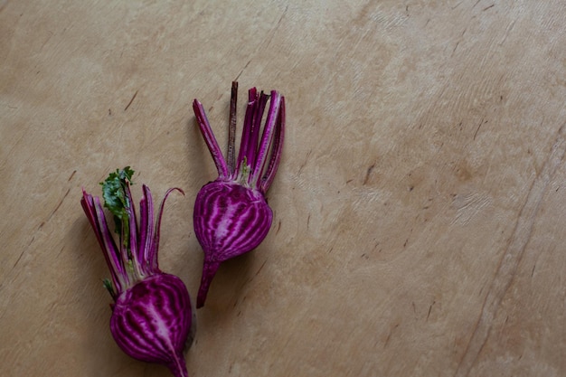 Halves of raw beet on wooden table