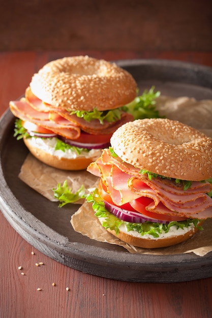 Bagel al prosciutto con crema di formaggio, pomodoro e cipolla