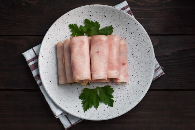 Ham and cheese rolls on a plate Delicious appetizer meat carbonate and cream cheese