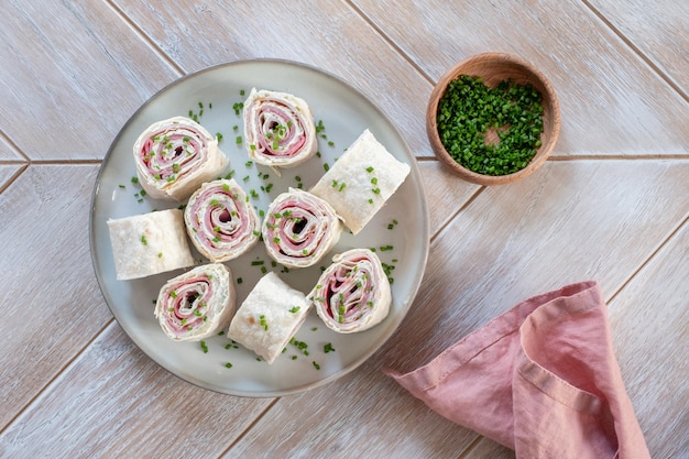 Ham and cream cheese rolled up in a tortilla