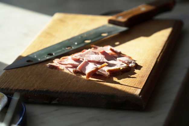 Ham sliced for sandwiches on a cutting board close-up