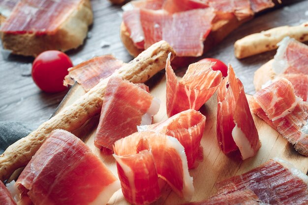 Ham still life cut with bread oil and tomato concept of gastronomy