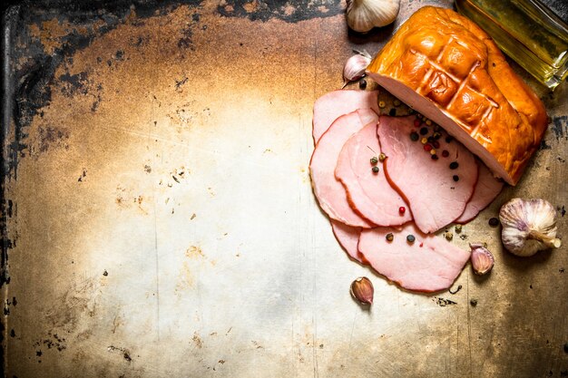 Ham with olive oil and garlic onn old rustic table .