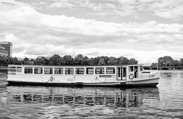 Hamburg Germany September 07 2017 vessel transport transportation Summer vacation wanderlust Cruiser boat float on river water on cloudy sky Water tour trip adventure Travelling by boat