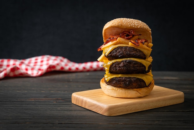 hamburger or beef burgers with cheese, bacon and french fries - unhealthy food style